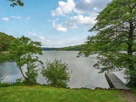 A view of a lake with trees and a dock at Hullet Hall at the Graythwaite Estate near Hawkshead