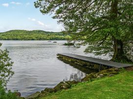 A view of a dock on water surrounded by trees at Hullet Hall at the Graythwaite Estate near Hawkshead