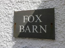 A sign with fox barn on a textured white wall at Fox Barn in Staveley