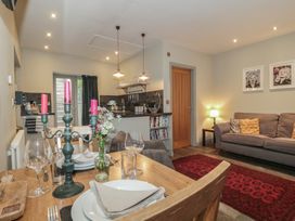 A kitchen and dining area with a table and sofa at The Stable in Deepdean near Ross-on-Wye