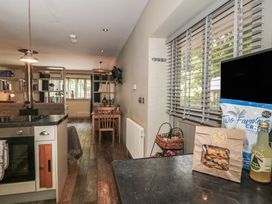 A kitchen with an oven and seating area at The Stable in Deepdean near Ross-on-Wye