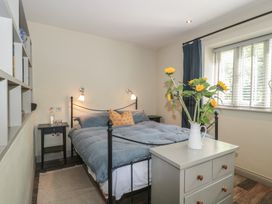A bedroom with a bed and bedside table at The Stable Deepdean near Ross-on-Wye