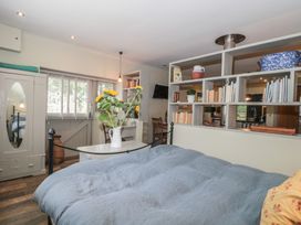 A bedroom with a bed and a bookcase at The Stable in Deepdean near Ross-on-Wye