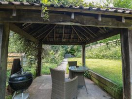 A gazebo with a table and chairs and a barbecue at The Stable Deepdean near Ross-on-Wye