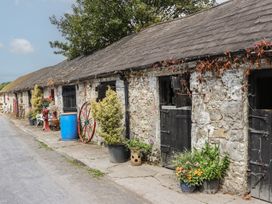 An outdoor area with stone buildings and plants at Mrs Delaney's Loft in Ardfinnan near Clonmel, County Tipperary