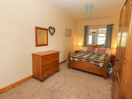 A bedroom with wooden furniture at Moybella Lodge in Lisselton near Ballybunion, County Kerry