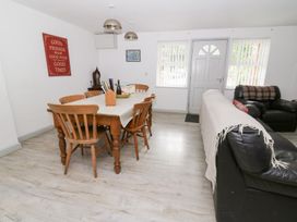 A dining room with a table and chairs at Cariad Cottage in Cross Inn