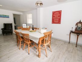 A dining room with a table and chairs at Cariad Cottage in Cross Inn