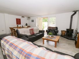 A living room with a sofa and coffee table at Cariad Cottage in Cross Inn