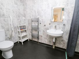 A bathroom with a toilet, sink, and towel rail at Cariad Cottage in Cross Inn