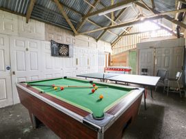 A game room with a pool table and foosball table at Cariad Cottage in Cross Inn