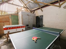 A games room with a ping pong table and foosball table at Cariad Cottage in Cross Inn
