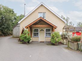 A house exterior with a sign at Cariad Cottage in Cross Inn