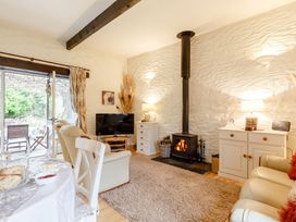 A living room with a television and fireplace at Wagtail Cottage East Taphouse