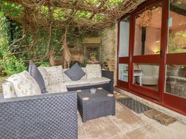 A conservatory with a sofa and coffee table at Wagtail Cottage in East Taphouse