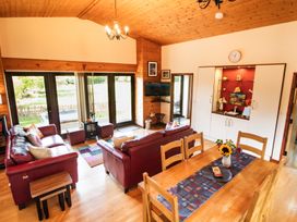 A living room with a dining table and sofa at Sycamore Lodge Nantmel near Rhayader