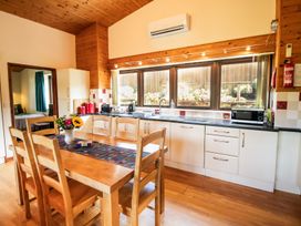 A kitchen with dining table and chairs at Sycamore Lodge Nantmel near Rhayader