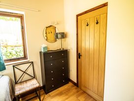 A bedroom with a window and furniture at Sycamore Lodge Nantmel near Rhayader