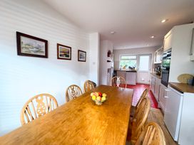 A kitchen with a dining table and chairs at 38 Dale End Brancaster Staithe near Burnham Market