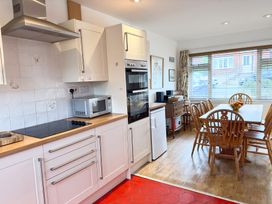 A kitchen with a dining table and chairs at 38 Dale End Brancaster Staithe near Burnham Market