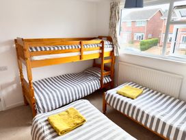 A bunk bed with a single bed in a bedroom at 38 Dale End Brancaster Staithe near Burnham Market