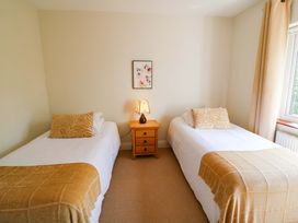 A bedroom with two single beds and a nightstand at No. 4 Lansdowne Village, Kenmare, The Ring of Kerry, County Kerry