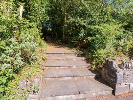 A staircase leading into a wooded area at No. 4 Lansdowne Village Kenmare, The Ring of Kerry, County Kerry