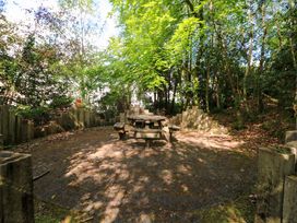 A garden area with a table and benches surrounded by trees at No. 4 Lansdowne Village, Kenmare, The Ring of Kerry, County Kerry