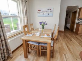 A dining room with a table and chairs at Grey Croft in Embleton