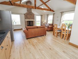 A living room with a sofa and dining table at Grey Croft in Embleton