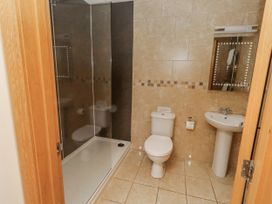 A bathroom with a shower, toilet, and wash basin at Grey Croft in Embleton