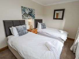 A bedroom with two single beds at Grey Croft in Embleton