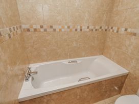 A bathtub with a tap in a bathroom at Grey Croft in Embleton