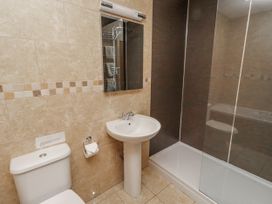 A bathroom featuring a sink and toilet with a shower at Grey Croft in Embleton