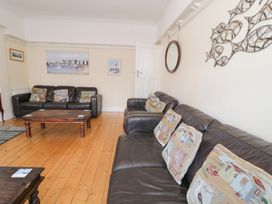 A living room with sofas and a coffee table at Meadway House Rhos-on-Sea