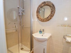 A bathroom with a shower and wash basin at Meadway House Rhos-on-Sea