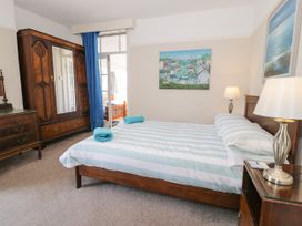 A bedroom with a bed and wardrobe at Meadway House Rhos-on-Sea