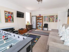 A snug with a foosball table and a television at Meadway House in Rhos-on-Sea