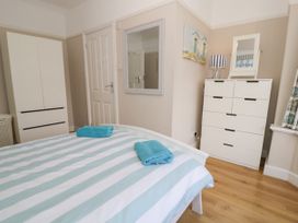 A bedroom with a bed and wardrobe at Meadway House Rhos-on-Sea