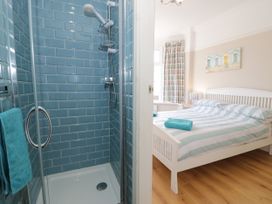 A bedroom with a shower and bed at Meadway House in Rhos-on-Sea