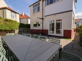 An outdoor dining area with a table and chairs at Meadway House in Rhos-on-Sea