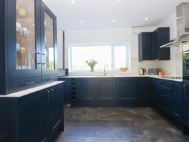 A kitchen with cabinets and countertop at Monarfon in Benllech near Red Wharf Bay