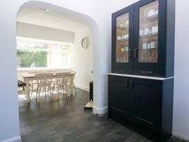 A dining room with a table and chairs at Monarfon Benllech near Red Wharf Bay