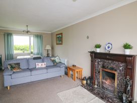 A living room with a sofa and fireplace at Findale, Carne near Rosslare, County Wexford