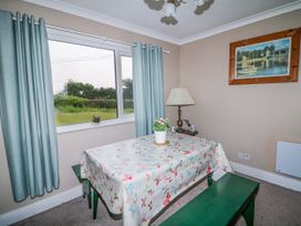 A dining room with a table and lamp at Findale in Carne near Rosslare, County Wexford