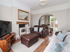 A living room with a television and fireplace at Sea View House in Hornsea