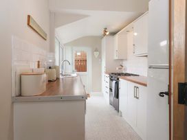 A kitchen with appliances and a door leading outside at Sea View House in Hornsea