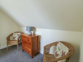 A chair and wooden drawer in an attic at Ty Ni Caeathro near Caernarfon