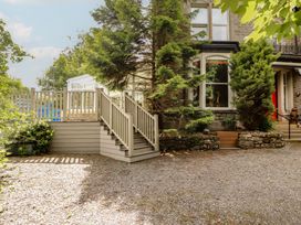 An outdoor area with stairs and a decking at Eden Lodge in Bardsea
