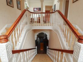 A staircase and railings in a hallway at Eden Lodge in Bardsea